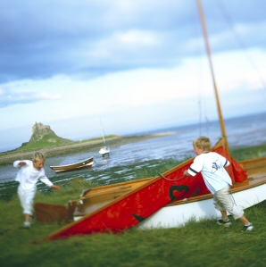 Boys playing in front of Lindisfarne Castle, Holy Island, Northumberland